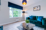 Spacious living room with comfortable seating and inviting atmosphere, perfect for relaxing or socialising during your stay.