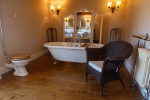 Roll-top bath in spacious bathroom