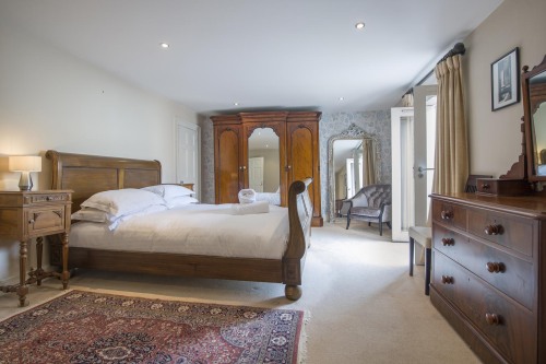Bedroom One, King-sized bed with french doors and view of the Minster. 