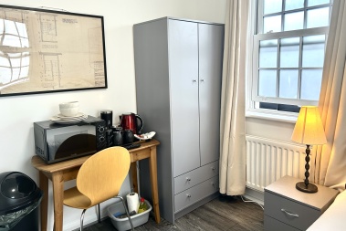 In each room: Microwave, plates, bowls, cutlery, tea, coffee, sugar, biscuits, kettle, mugs, drinking glasses