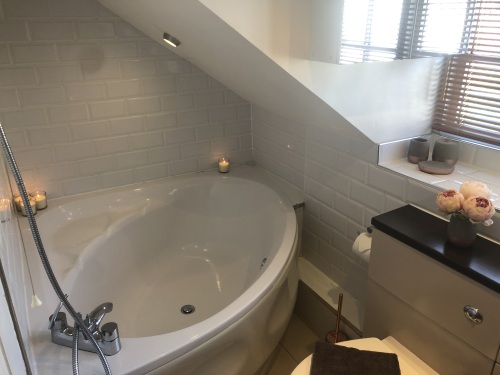 En-suite to master bedroom. Corner bath with shower over