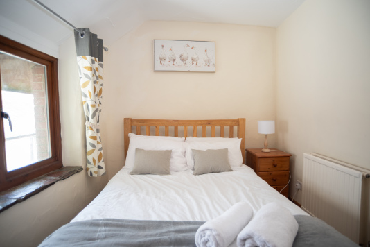Hotel-Quality Double Room - Crisp white linens, soft throws, fresh towels and a warm bedside lamp — everything you need to wake up properly rested.