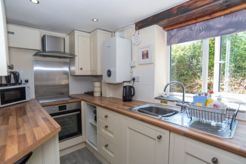 The fully equipped kitchen offers everything needed for self-catering stays, from family breakfasts to evening meals.