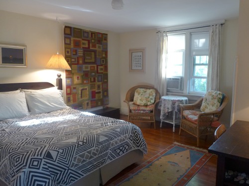 South room with queen bed and shared bathroom
