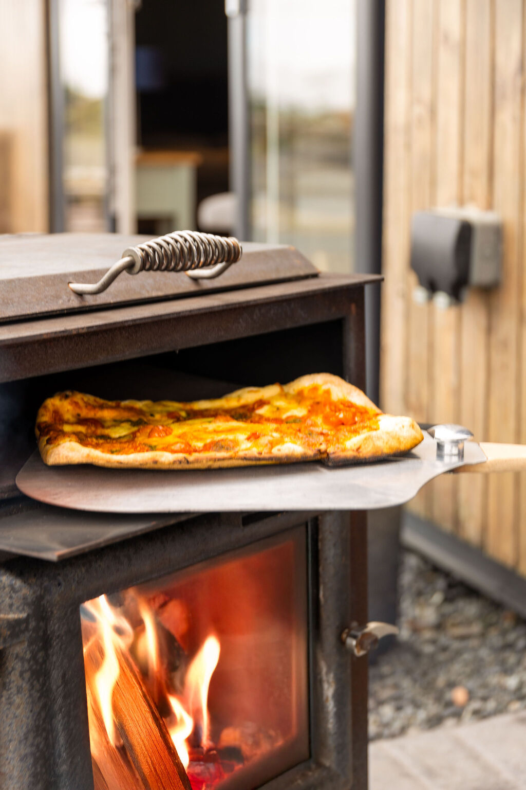 [{'Text': 'Fresh pizza cooked over wood-burner', 'CultureCode': 'en-GB'}] glamping cabins and grounds, photo 26 of 32