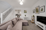 Living room with large sofa, TV, dining area and WiFi