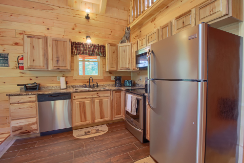 Closeup of Fridge and Full Kitchen
