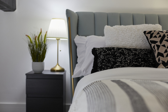 Sleep easy in this spacious double bedroom with soft linens and a relaxing ambience.