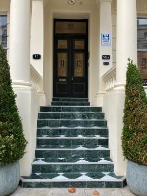 Picture represents the exterior of the main entrance of the building 