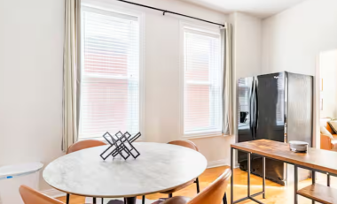 Bright and inviting, the dining space features large windows that fill the area with natural light and a full fridge ready for all your culinary adventures or quick snacks.