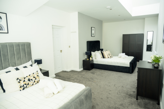 Relax in this well-lit two-single bedroom, designed for comfort and rest.