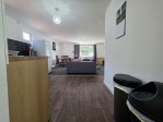 The open plan lounge, dining, and kitchenette area is the social heart of this 2-bedroom flat. Featuring a 55" Smart TV for entertainment, a dining table for 4, and a sofa bed that sleeps 2, it's the perfect space for contractors, groups, and weekend travellers to relax, eat, and unwind.