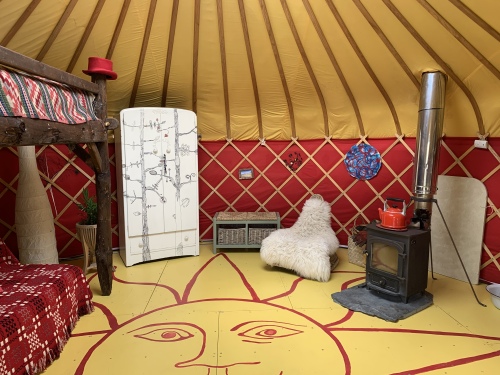 Cai Yurt with its vibrant living space and wood burning stove
