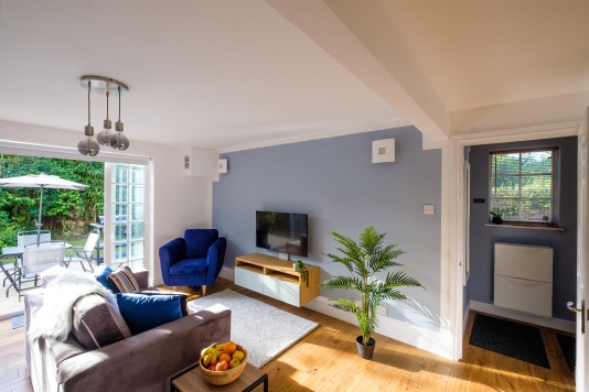 The living/dining area opens out on to a terrace with outdoor dining furniture, a BBQ/grill, and a secluded, fully enclosed private garden for the exclusive use of our guests.