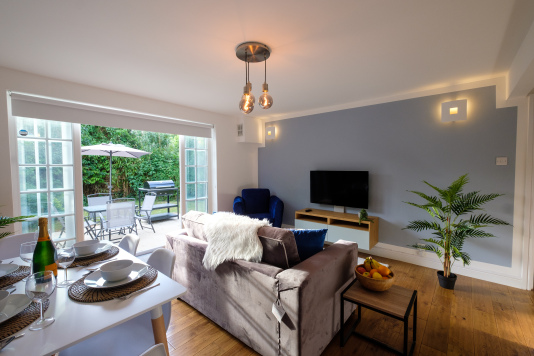 The living/dining area opens out on to a terrace with outdoor dining furniture, a BBQ/grill, and a secluded, fully enclosed private garden for the exclusive use of our guests.