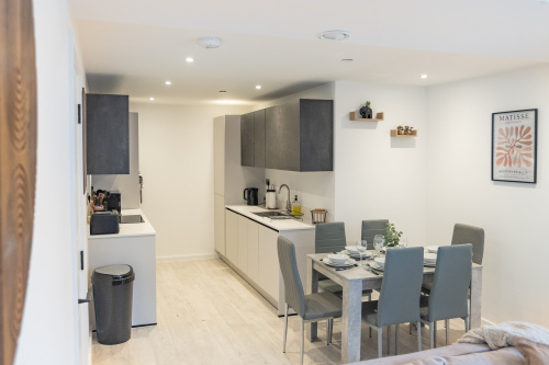 Modern kitchen and dining space, fully equipped for cooking and shared meals.