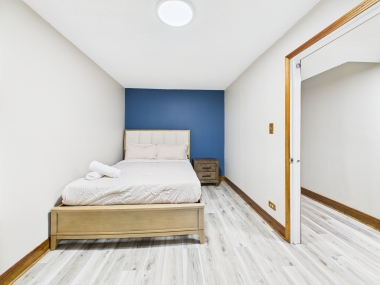 Alternate view of Bedroom Two, revealing its airy flow and golden light.