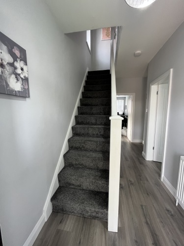 Stairs leading to bathroom and three bedrooms