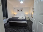 The first bedroom is designed with contractors and short-stay guests in mind. Featuring a comfortable double bed, a spacious wardrobe for unpacking, and a dedicated workstation, it offers the perfect balance of productivity and relaxation for both weekday stays and weekend getaways.