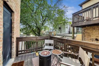 Enjoy the fresh air on this charming balcony featuring cozy seating and a stylish fire pit table. Surrounded by natural greenery and city views, this outdoor space is perfect for morning coffee, evening relaxation, or stargazing.
