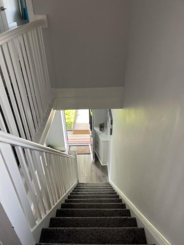 Stairs leading down to living room / dining area and kitchen