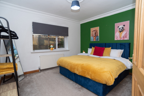 Downstairs bedroom with zip-and-link beds offering flexible sleeping arrangements, complete with hotel-style linens and towels. Includes a clothing rail and a spacious, comfortable layout.