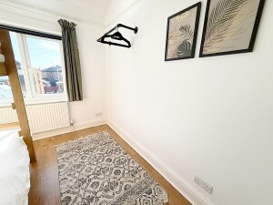 This charming bedroom features a cozy bunk bed, perfect for children. With vibrant décor and a playful atmosphere, it’s the ideal space for little ones to relax and recharge.