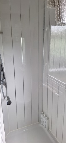 with toiletries, bathmat, toilet rolls