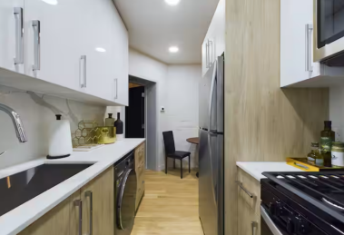 Enjoy the ease of in-unit laundry with a sleek washer and dryer, clean up effortlessly with the dishwasher, and chill a bottle of wine in the ice bucket for a cozy night in. This kitchen makes hosting or relaxing seamless and stylish.