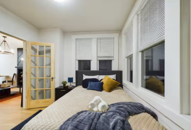 Drift into comfort on the inviting king bed, dressed with cozy sheets and plush pillows for a restful night. Adjustable blinds let you control the natural light, creating the perfect ambiance for relaxation in this thoughtfully designed space.