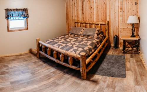 Lower level bedroom with queen size log bed