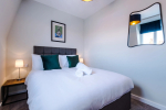A cosy bedroom featuring a comfortable double bed, perfect for restful nights and relaxing stays.