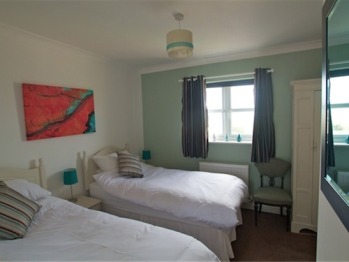 Twin bedroom with en suite shower room and sea views