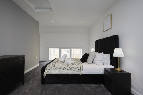 Sleep easy in this spacious double bedroom with soft linens and a relaxing ambience.