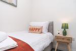 A clean, comfortable single bed within a shared bedroom, complete with its own private en suite for added convenience.
