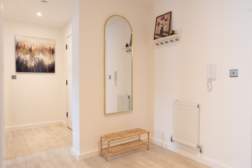 Welcoming entrance area with mirror and space for coats and shoes.