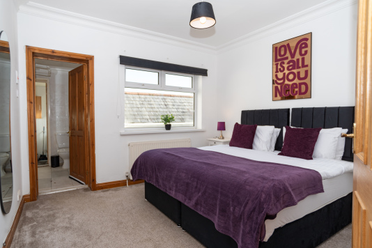 One of six bedrooms, this spacious room offers a king-size zip-and-link bed, configurable as singles for flexible sleeping arrangements.