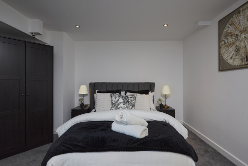 Sleep easy in this spacious double bedroom with soft linens and a relaxing ambience.