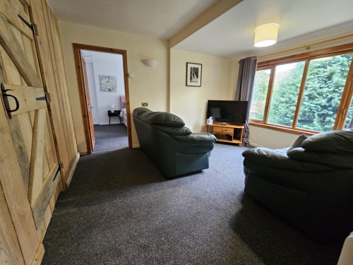 Lounge looking to bedroom 1 with bedroom 2 door on the left