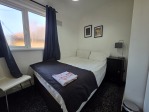 Designed with both contractors and leisure guests in mind, this bedroom combines comfort with practicality. A plush double bed ensures a great night's sleep, while the wardrobe provides ample storage. Towels are included, so you can travel light and settle in straight away.
