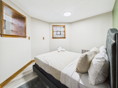 Bedroom Three — soft neutrals and tailored simplicity for restful nights.