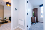 Spacious living room with comfortable seating and inviting atmosphere, perfect for relaxing or socialising during your stay.