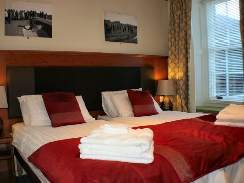Luxury bedroom configured with two single beds