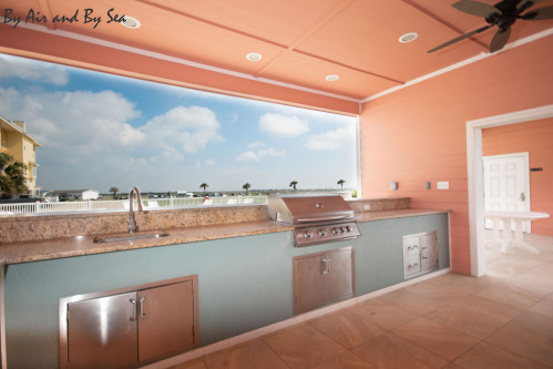 the community pool also has an outdoor kitchen