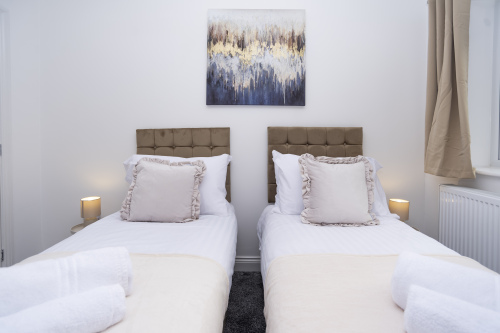 Two comfortable single beds offering flexible sleeping arrangements — perfect for colleagues, friends or guests wanting their own space.