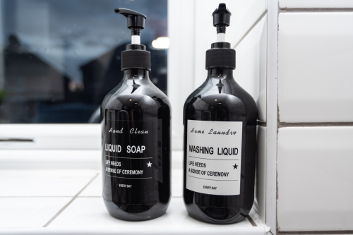 A clean, fully stocked sink area with everything guests need to keep the kitchen spotless.