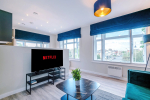 Spacious living room with comfortable seating and inviting atmosphere, perfect for relaxing or socialising during your stay.