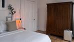 Bedroom with classic wooden wardrobe and warm lighting