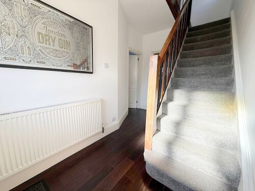 The welcoming hallway leads to a staircase, offering a stylish and spacious entryway to your holiday home. With thoughtful décor, it sets the tone for a relaxing stay.







