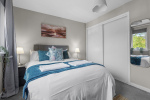 Double Bedroom with blackout blinds and curtains, and double wardrobe, chest of drawers and bedside tables